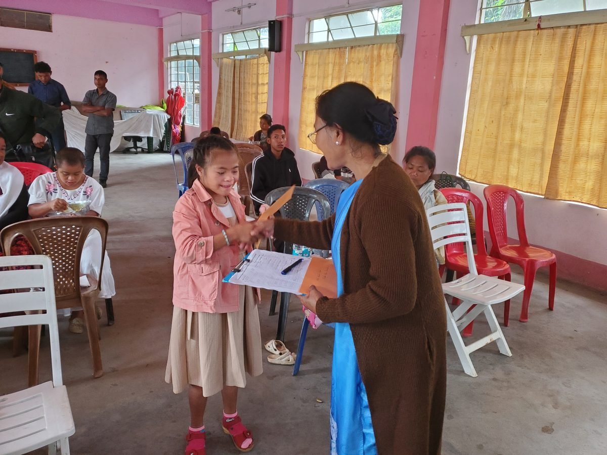 Child receiving recognition at the Aadya Foundation outreach programme